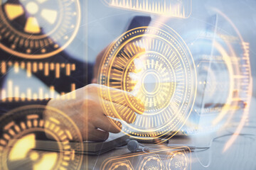 Double exposure of man's hands holding and using a digital device and tech theme hologram drawing. Technology concept.