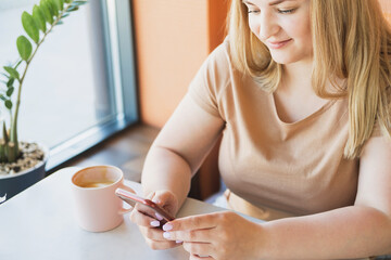Beautiful woman is resting in a cafe with a cup of coffee. 