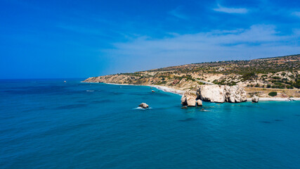 Fototapeta premium Cyprus. Aphrodite's rock aerial view Petra-Tu-Romiou. Bay of Aphrodite. Mediterranean sea. Seascape rocks. Paphos. Kouklia. The Cyprus beaches. Turquoise sea. Coast of the Republic of Cyp