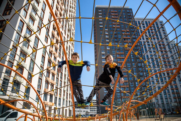 The children are playing on a playground in a school yard.