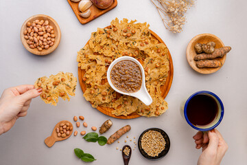 Rempeyek or peyek kacang is a deep-fried savoury Indonesian-Javanese cracker made from flour (usually rice flour) with peanut, lime leaves and other ingredients, bound or coated by crispy flour batter