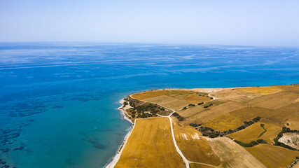 Aerial view of coastline of Cyprus beach.The steep stone cliffs and deep blue sea waves crushing in...