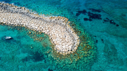 Aerial view of coastline of Cyprus beach.The steep stone cliffs and deep blue sea waves crushing in...