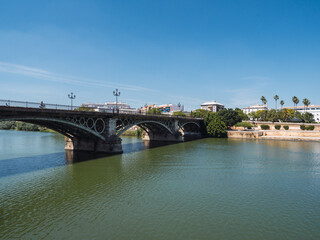 Fototapeta na wymiar View of the Isabel II bridge ( Triana bridge) in Seville, on the Guadalquivir river