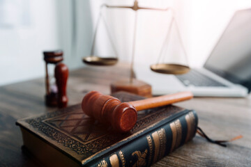Justice and law concept.Male judge in a courtroom with the gavel, working with, computer and...