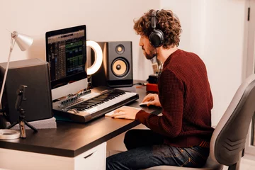 Tuinposter Music producer working at home music studio © carlesmiro