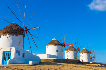 Windmills in row closeup with deep blue sky in Mykonos island cyclades Greece - 440253410