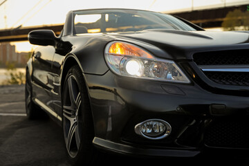 Luxury black convertible car outdoors, closeup view