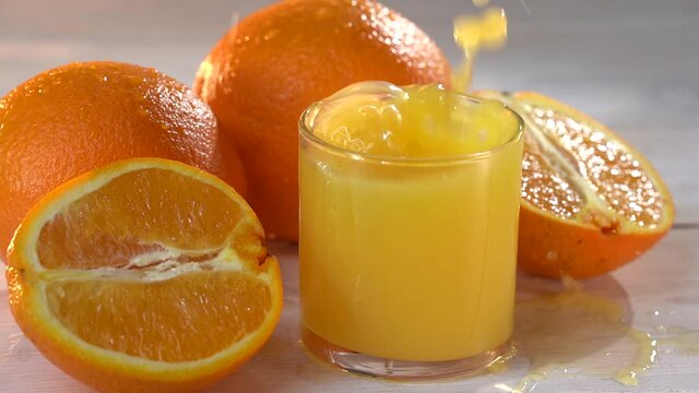 Ice drops to the glass with fresh orange juce
