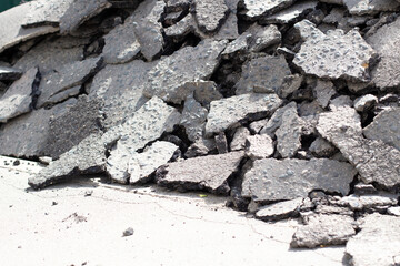 Broken asphalt. Pieces of an asphalt road.