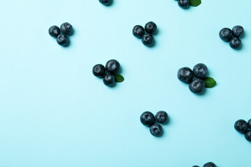 Fresh blueberry with leaves on blue background