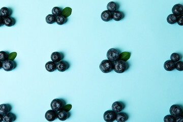 Fresh blueberry with leaves on blue background