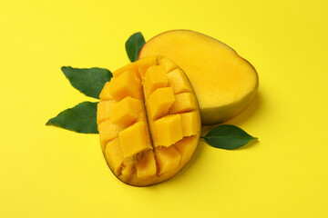 Ripe mango fruit on yellow background, close up
