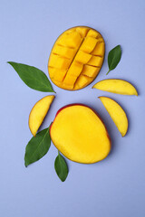Tasty ripe mango fruit on violet background