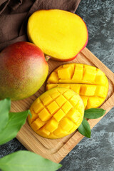 Tasty ripe mango fruit on black smokey table