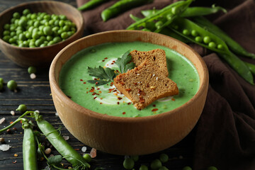 Concept of tasty eating with pea soup on wooden table