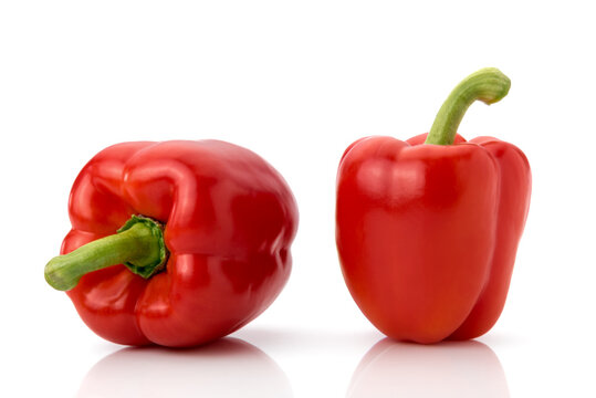 Two red bell peppers isolated on white