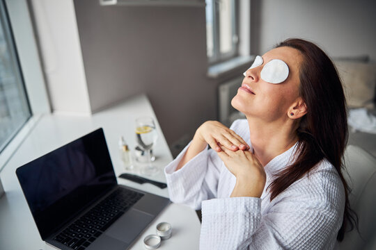 Relaxed woman doing mask for her eyes