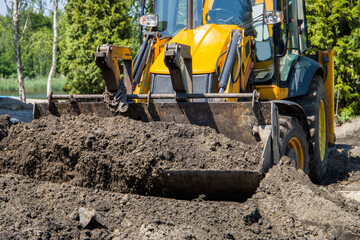wheel loader at work. Earth in the loader bucket. Bucket Loader Earth Moving.