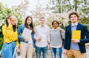 Concepts about friendship, teamwork, immigration and unity. Multiracial group of five friends standing in a row, together in university campus, outdoor shot about teamwork and cooperation.