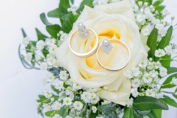 Wedding bouquet together with rings.