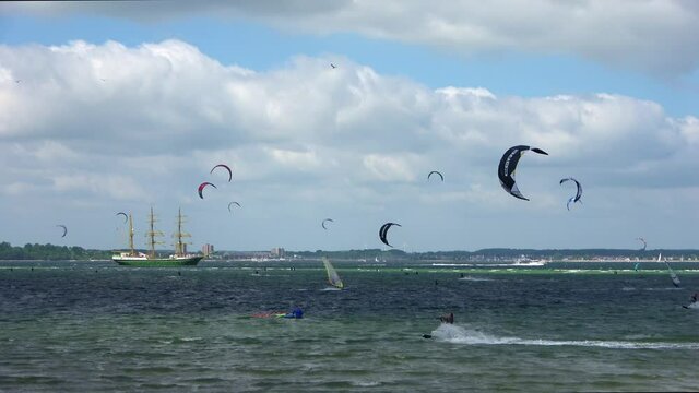 Time lapse of kite surfing activity at the Baltic Sea beach of Laboe in Germany on a sunny day