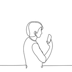 woman holds the phone in front of her vertically and looks at it - one line drawing. concept of taking a photo, looking for a communication signal, mobile video filming, call video communication
