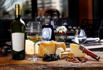 White wine accompanied by various cheeses.