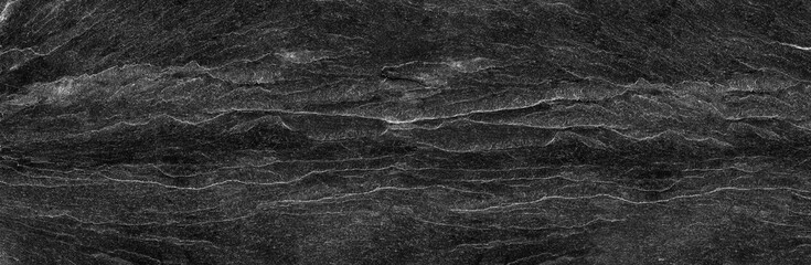 Black rock background. Dark gray stone texture. Black grunge background. Mountain close-up. Distressed backdrop.