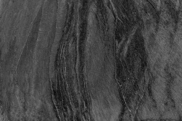 Black and white background. Gray rock texture. Grunge stone background. The texture of the mountains. Close-up. Grunge banner with volumetric rock texture