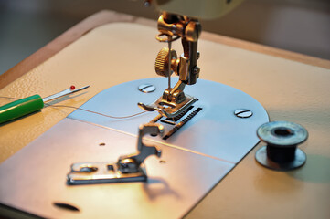 Fototapeta na wymiar Sewing machine. Sewing machine foot, sewing machine detail