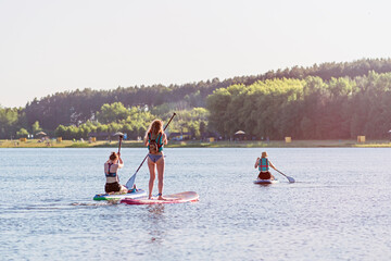 sup board at sunset. outdoor summer activity.