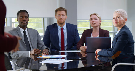 Multiethnic businesspeople sitting at table on corporate meeting