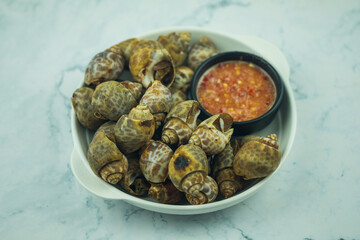 Grilled Spotted Babylon served with spicy red chilli sauce