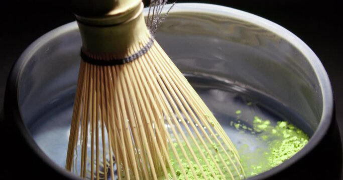 Preparing Japanese organic Matcha green tea powder with bamboo whisk, Tradition