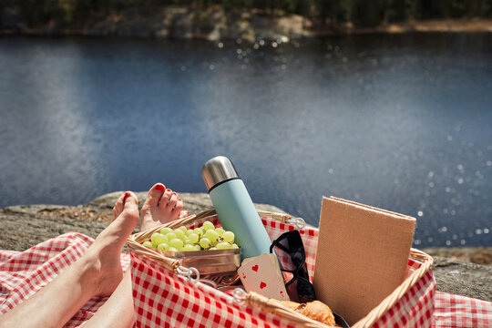 Female feet and picnic basket