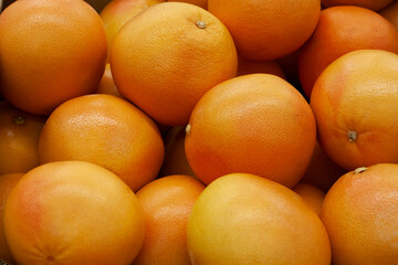 Background of ripe grapefruits in the store