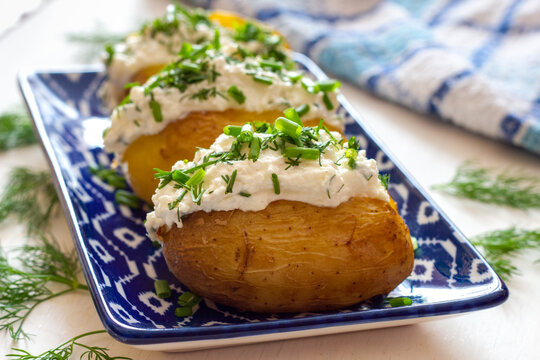 Baked potatoes with cottage cheese paste called "gzik" sprinkled with chives and dill

