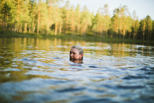 Woman Swimming In Lake