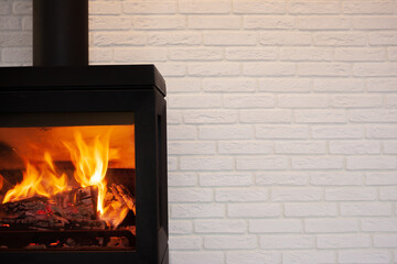 Moderm style cast iron fireplace with white brick background
