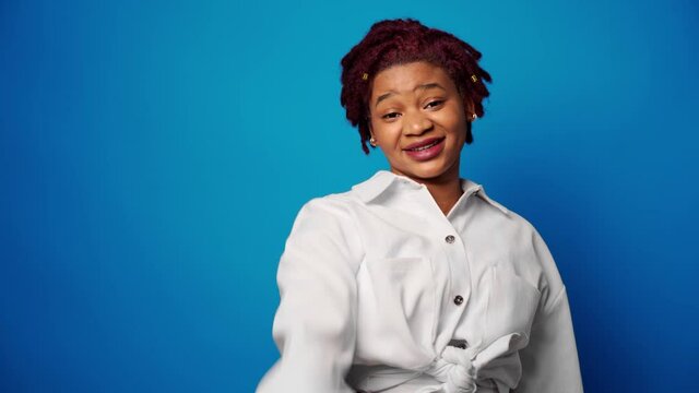 Dissatisfied afro american woman showing her refusal, denies something against blue background