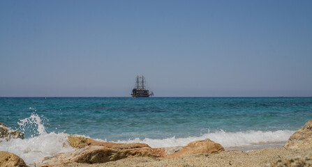 Alanya. Turkey. June 2, 2012; A masted pleasure ship on the horizon of the blue sea.