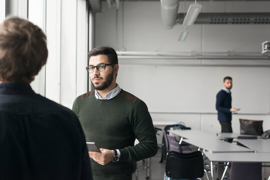 Coworkers talking in board room