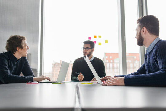 Coworkers talking in board room