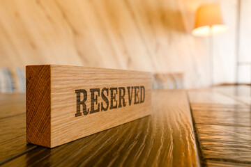 the "Reserve table" sign is located on the table in the restaurant. Reserved label