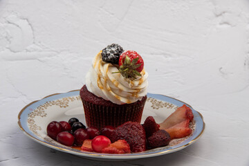 cupcake with strawberries on a light background close-up
