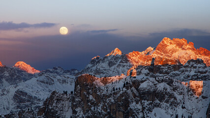Full moon at sunset in the Dolomities