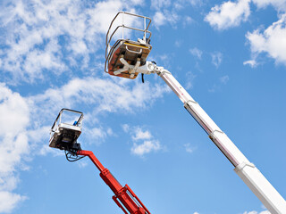 Cranes with cradles on sky
