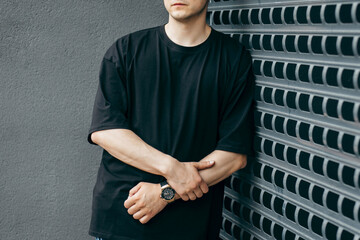 Man wearing black blank t-shirt with space for your logo or design. Mock up