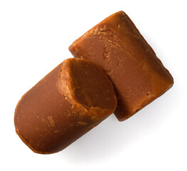 black cylindrical palm sugar isolated on white background, top view